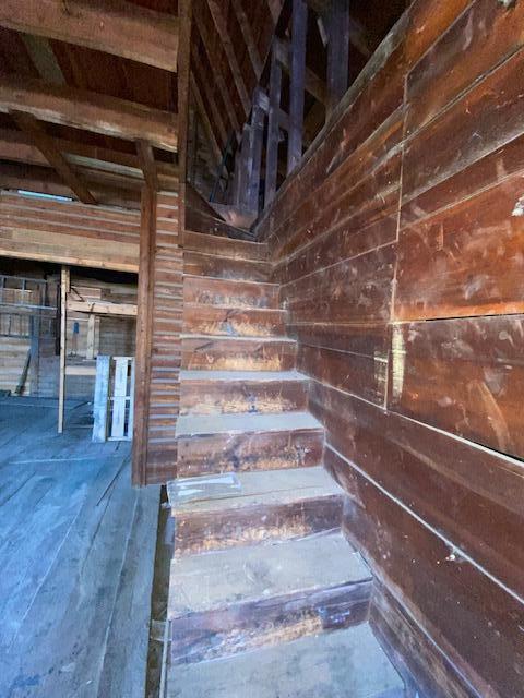 stairs with wood walls