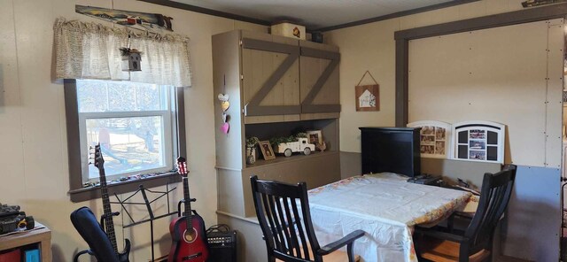 dining area featuring a barn door and crown molding