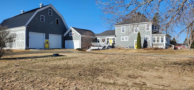 rear view of house featuring a garage