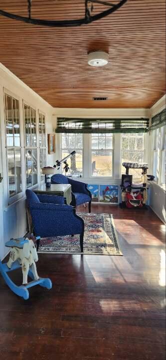 sunroom / solarium featuring wooden ceiling