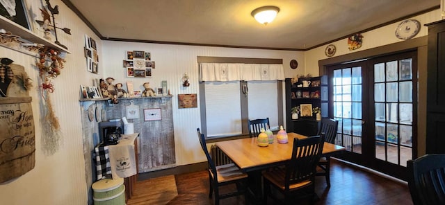 dining space with crown molding, dark hardwood / wood-style floors, and french doors