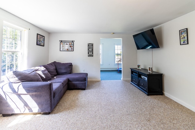 living room with a baseboard heating unit and light carpet