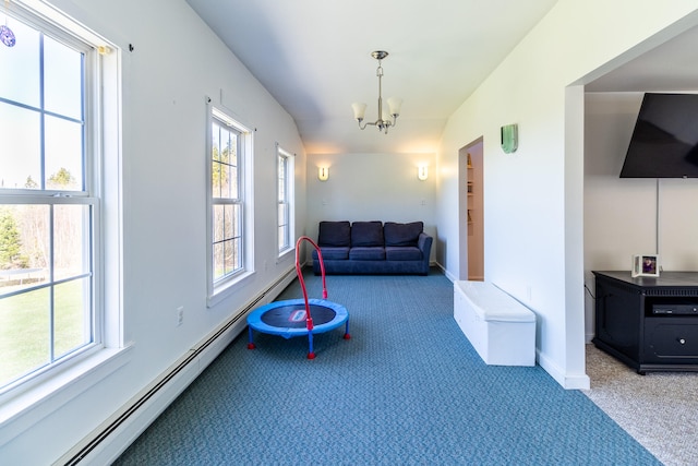 interior space featuring a wealth of natural light, dark colored carpet, an inviting chandelier, and baseboard heating