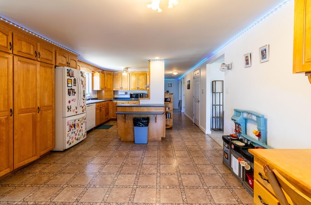 kitchen featuring sink, white appliances, and light tile floors