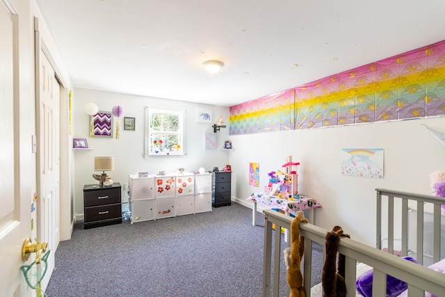 carpeted bedroom with a nursery area