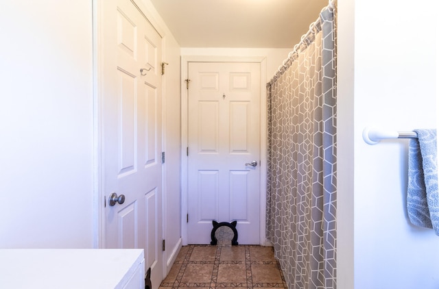 bathroom featuring tile flooring and vanity