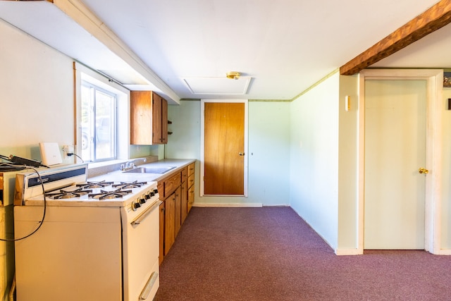 kitchen featuring sink, white range with gas cooktop, and dark carpet