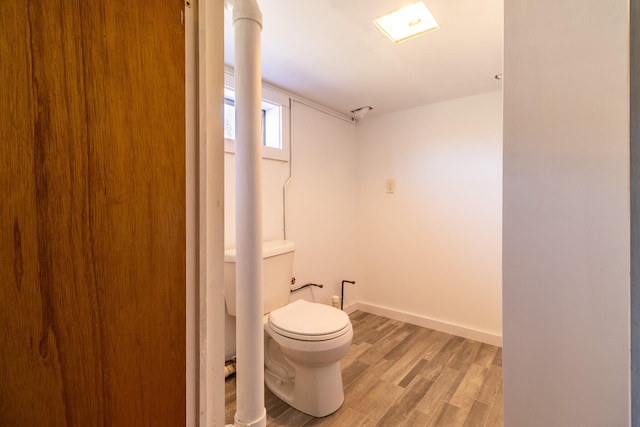 bathroom with wood-type flooring and toilet