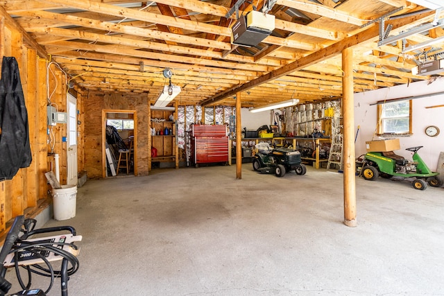 garage with a workshop area and a garage door opener