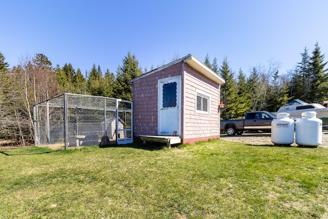 view of shed / structure featuring a lawn