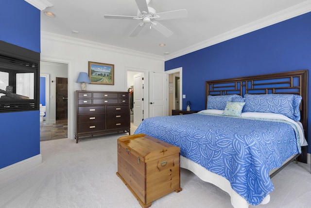 carpeted bedroom featuring ornamental molding, ceiling fan, and ensuite bathroom