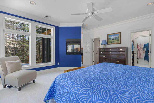 carpeted bedroom with multiple windows, crown molding, and ceiling fan