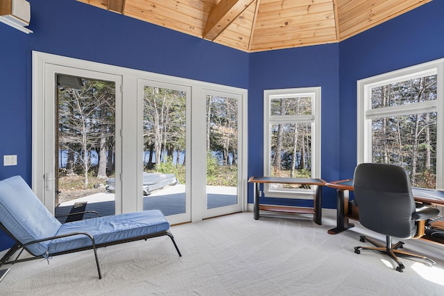 carpeted office space with wood ceiling, a towering ceiling, and a water view