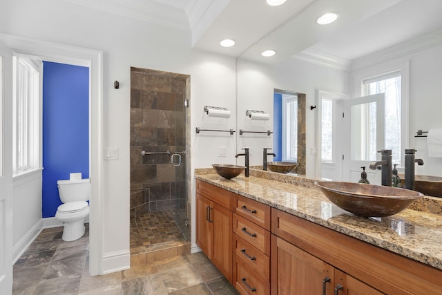 bathroom with an enclosed shower, vanity, crown molding, and toilet