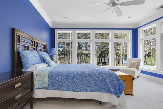 bedroom with crown molding, light colored carpet, and ceiling fan