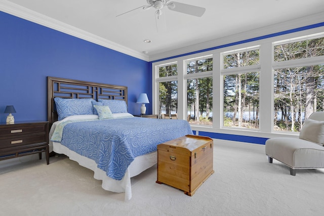 bedroom with crown molding, ceiling fan, and carpet