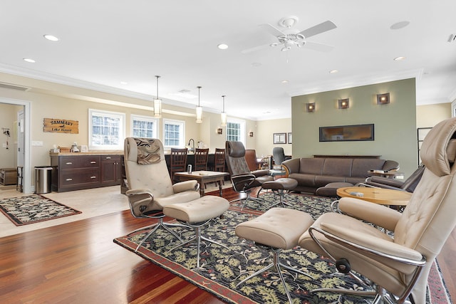 living room featuring crown molding, ceiling fan, and light hardwood / wood-style floors