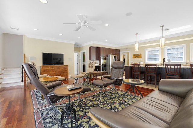 living room with ornamental molding, dark hardwood / wood-style floors, and ceiling fan