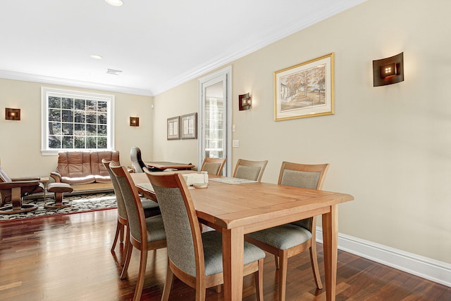 dining space featuring ornamental molding and dark hardwood / wood-style floors