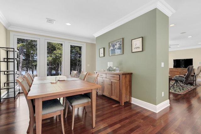 dining space featuring crown molding and dark hardwood / wood-style floors