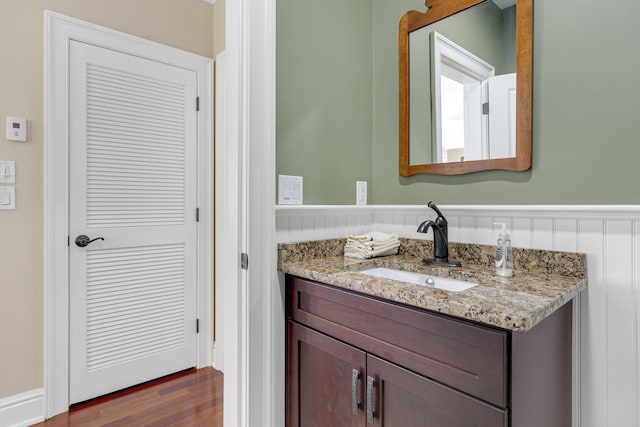 bathroom featuring hardwood / wood-style flooring and vanity