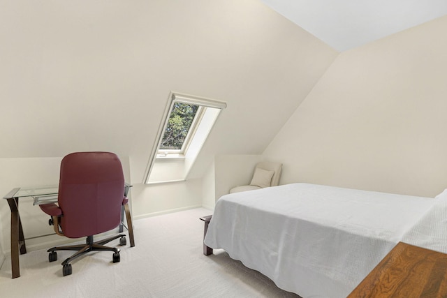 bedroom with carpet floors and vaulted ceiling with skylight