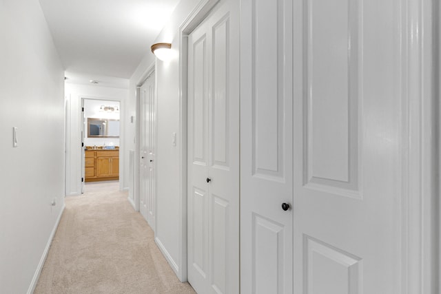 hall featuring light colored carpet