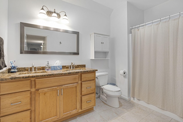 bathroom with tile patterned flooring, vanity, and toilet