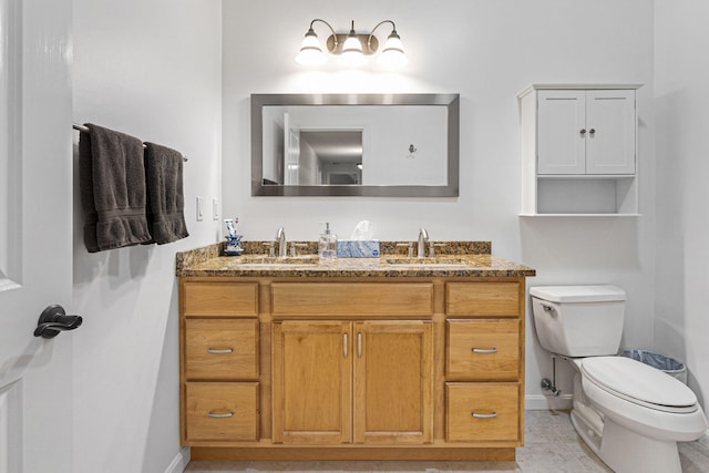 bathroom with vanity, toilet, and tile patterned flooring