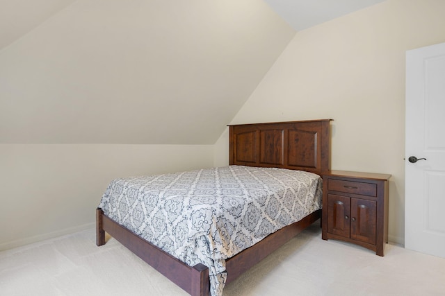 bedroom featuring lofted ceiling and light colored carpet