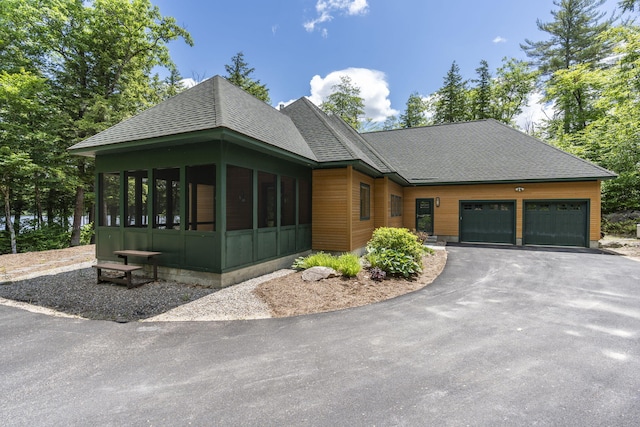 view of front of house featuring a garage and a sunroom