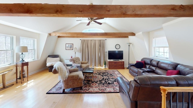 living room featuring vaulted ceiling with beams, ceiling fan, a healthy amount of sunlight, and light wood-type flooring