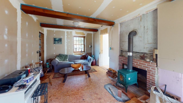 living room with wood-type flooring, beam ceiling, and a wood stove