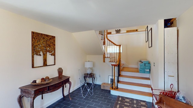 staircase with dark tile flooring