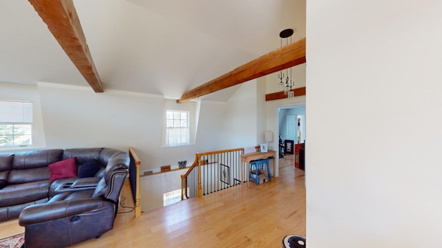 living room featuring beam ceiling and light wood-type flooring