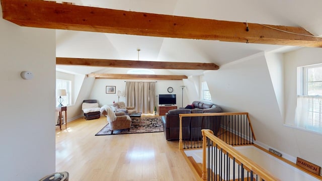 living room with beam ceiling and light wood-type flooring