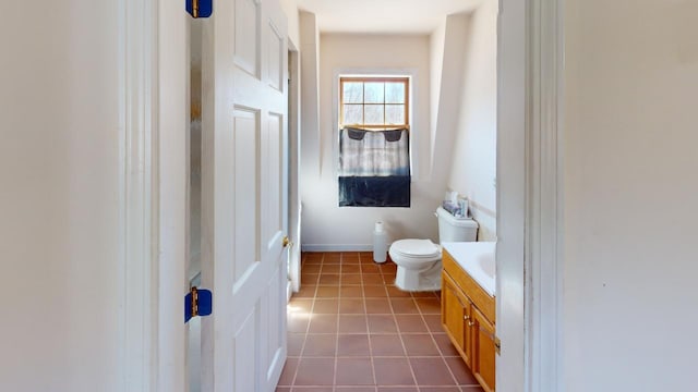 bathroom with toilet, tile flooring, and vanity