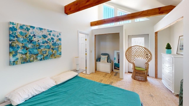 tiled bedroom with beamed ceiling and a towering ceiling