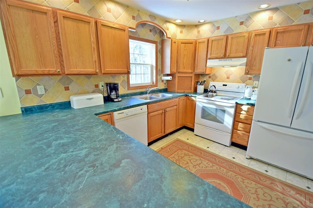 kitchen featuring sink, white appliances, and light tile patterned floors