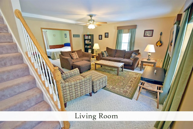 carpeted living room with ceiling fan