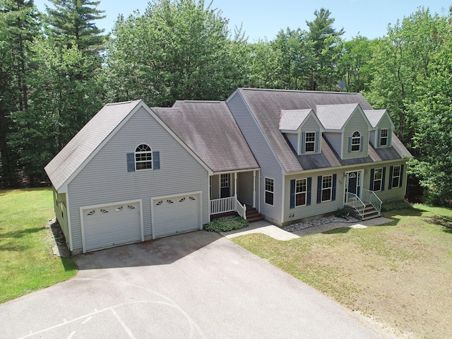 new england style home featuring a front yard and a garage