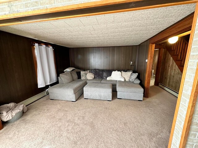 carpeted living room featuring a baseboard radiator and wood walls