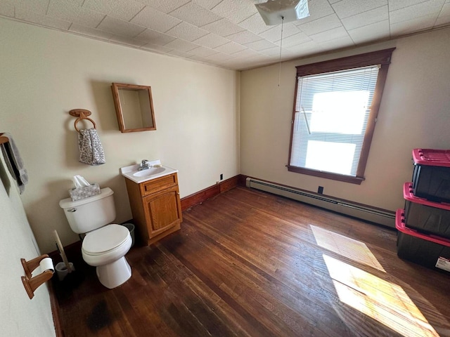 bathroom with vanity, a baseboard radiator, hardwood / wood-style flooring, and toilet