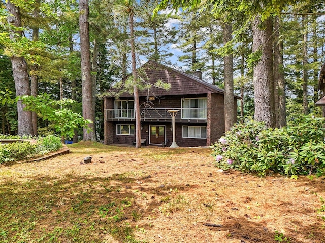 back of house with a lawn