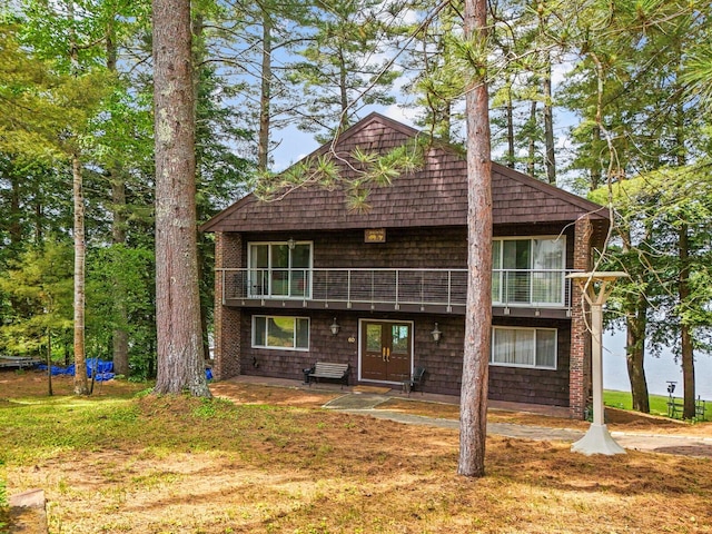 view of property featuring a patio area and a front lawn