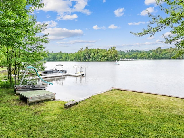 view of dock featuring a water view and a lawn