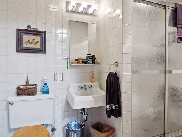 bathroom featuring sink, tile walls, an enclosed shower, and toilet