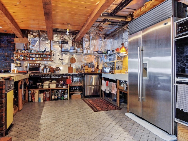 kitchen with built in fridge, wooden ceiling, and beamed ceiling