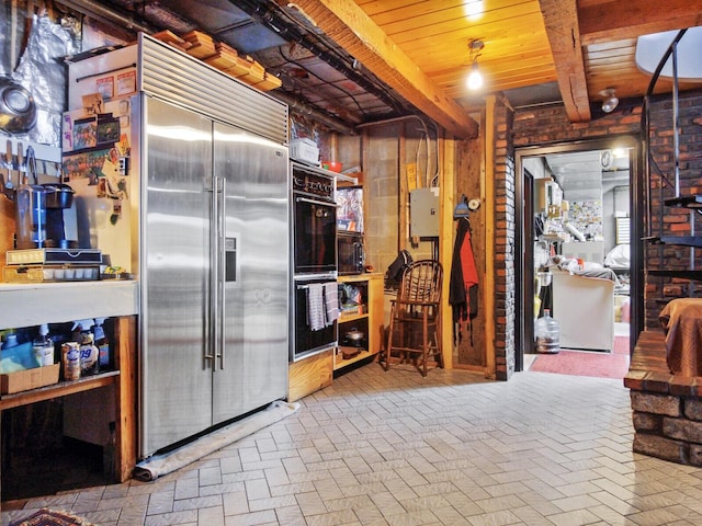 kitchen featuring double oven, wood ceiling, beam ceiling, and built in fridge