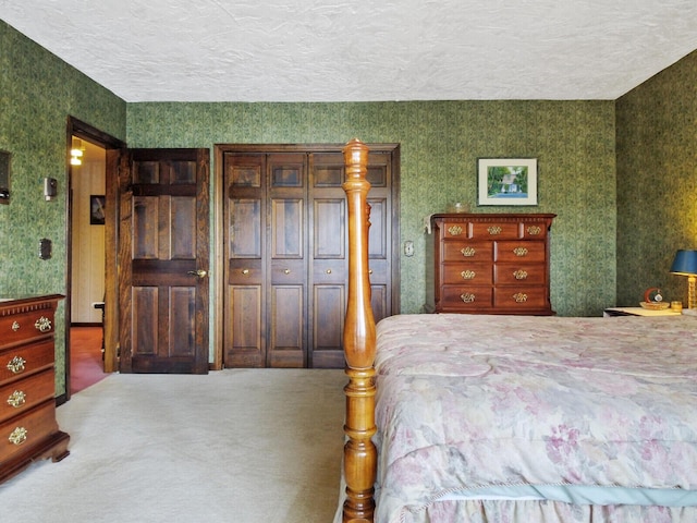 bedroom with a textured ceiling and a closet